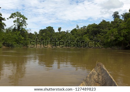 deep in the Ecuadorian Amazon in a dugout canoe - stock photo