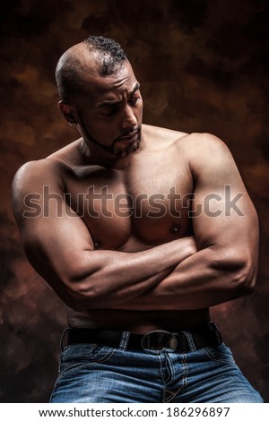 Muscular, Young Brunette Man Sitting And Posing In 