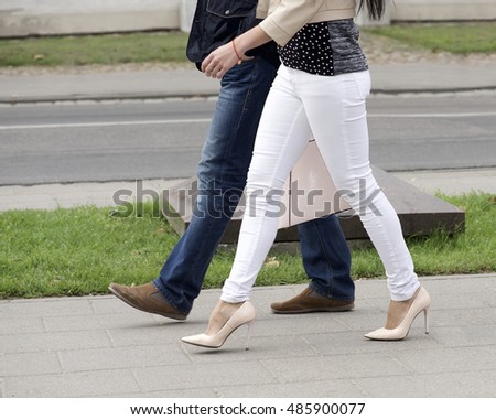 http://thumb10.shutterstock.com/display_pic_with_logo/1054405/485900077/stock-photo-man-and-woman-walking-in-the-street-people-going-in-the-street-on-sunny-day-abstract-photo-legs-485900077.jpg