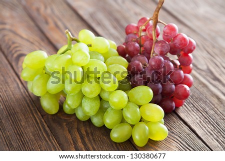 Grapes on a wooden table - stock photo