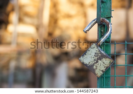  - stock-photo-open-padlock-hang-on-a-green-gate-144587243