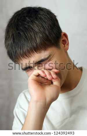 stock-photo-sorrowful-young-teenager-crying-on-gray-background-124392493.jpg
