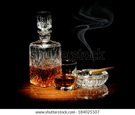 stock-photo-studio-shot-of-whisky-in-a-carafe-and-glass-and-a-cigar-in-ashtray-isolated-on-black-184025507.jpg