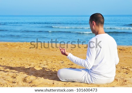  - stock-photo-yogi-man-dressed-in-white-meditating-on-the-beach-101600473