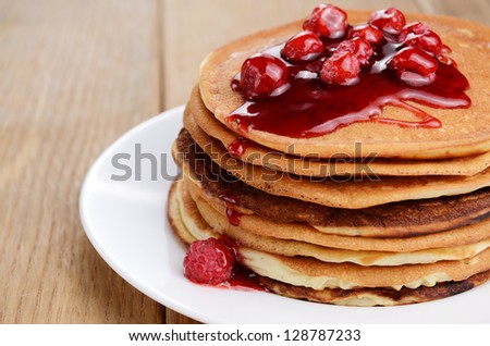 stock-photo-delicious-pancakes-with-raspberries-on-the-wooden-kitchen-table-with-copy-space-128787233.jpg