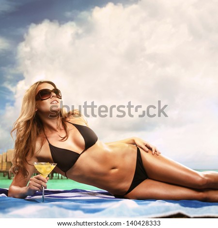 Beautiful Sexy Blond Woman Drinking Cocktail By The Sea - stock photo