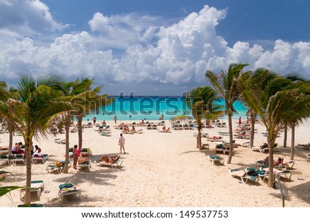  - stock-photo-playa-del-carmen-mexico-july-unidentified-tourists-on-the-beach-of-playacar-at-caribbean-sea-149537753