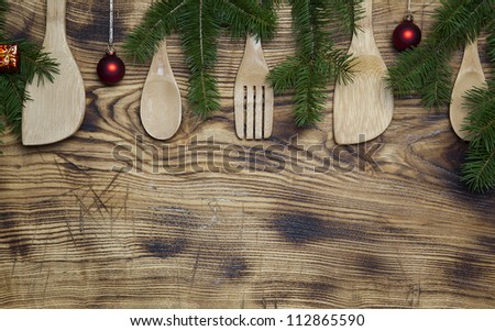  - stock-photo-row-of-wooden-spoons-and-utensils-on-grainy-wooden-background-with-green-christmas-tree-branches-112865590