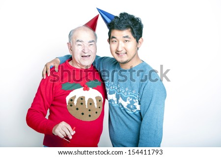 Portrait of a Senior adult man and a young Asian man wearing Christmas