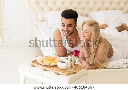 http://thumb10.shutterstock.com/display_pic_with_logo/534712/486184567/stock-photo-young-couple-lying-in-bed-eat-breakfast-morning-with-red-rose-flower-happy-smile-hispanic-man-and-486184567.jpg