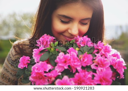 http://thumb10.shutterstock.com/display_pic_with_logo/580987/190921283/stock-photo-young-cute-woman-smelling-pink-flowers-190921283.jpg