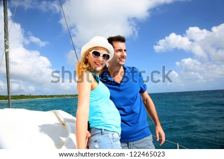 stock photo smiling rich young couple on a sailboat in caribbean sea 122465023