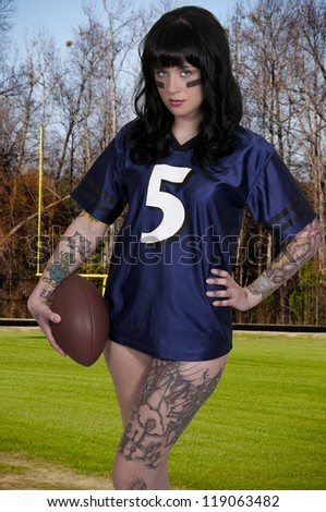 Beautiful young woman playing a game of football