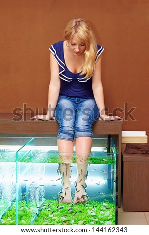  - stock-photo-young-girl-taking-fish-pedicure-treatment-rufa-garra-spa-procedure-144162343