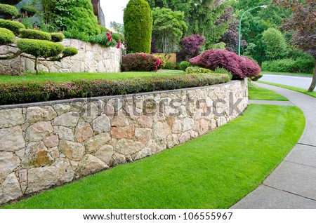 ... bushes on the leveled front yard. Landscape design. - stock photo