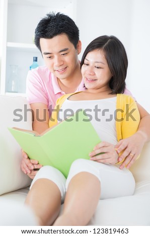 http://thumb10.shutterstock.com/display_pic_with_logo/85819/123819463/stock-photo-asian-couple-reading-book-on-sofa-happily-123819463.jpg