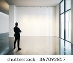 businessman stands in blank...