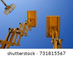 stock-photo-scissor-lift-platform-cherry-picker-aerial-platform-with-bucket-three-yellow-construction-731815567.jpg