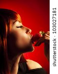 Stunning sexy lady, young beautiful woman eating strawberry, female face profile, close up portrait with closed eyes, stylish red hair and red lips fashion makeup, expressing desire, passion and love - stock photo