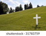 white cross on a grassy slope...