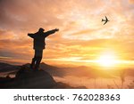 Small photo of silhouette of successful man on top of mountains both hands up - mission accomplished - destination achieved - travel nature concept - View point 103 Patang, Chiangrai . Thailand