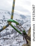 Small photo of Safety rope threaded through a climbing carabiner quickdraw