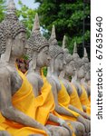 row of sacred buddha images in...