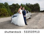 Small photo of in the wedding day the marriage couple make a break with convertible car