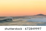 breaking wave at sunrise at ...