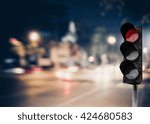Small photo of Red traffic light on the road during the night. light sign for car stop and speed reduction. Dangerous,warning signal,semaphore driving. Abstract blurred light background.