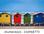 row of brightly colored huts in ...