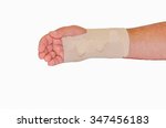 injured male hand wrapped with...