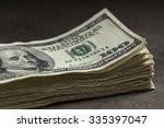 stock-photo-stack-of-one-hundred-dollar-bills-on-a-stone-table-top-shallow-depth-of-field-with-focus-on-335397047.jpg