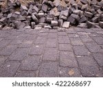 Small photo of regular brick pattern of the pavement merging into chaotic pattern of bricks thrown together in the distance