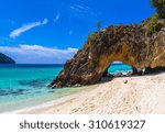 stone arch with beautiful beach ...