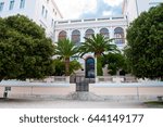 Small photo of Entrance to the rectorate of the University of Zadar, Croatia. White building with arch windows, surrounded by green trees and palms.