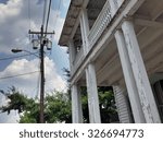 Small photo of A condemned building on a beautiful summer day in a small town, Hillsborough, NC