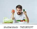 Small photo of a man with a beard and an orgasmic quantity of vegetables in front of him.