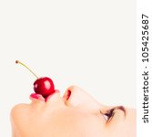 Close up portrait of beautiful young woman with cherry against white background. - stock photo