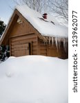wooden hut under snow in winter
