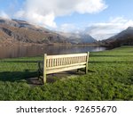 a wooden bench on green grass...