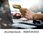 stock-photo-online-shopping-hands-holding-credit-card-and-using-laptop-408534343.jpg