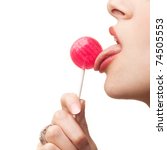 Woman licking a red shiny lollipop. Close up against white background. - stock photo