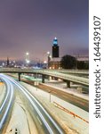 Small photo of Stockholm Cityhall at night with transportation light trail Sweden