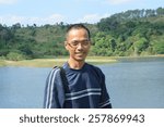Small photo of thin asian man wearing eyes glass with skin head hair fashion smiling to camera