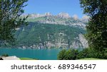Small photo of The mountain chain Churfirsten in Switzerland and a part of the Lake Walensee, steep rocks and turquoise-coloured water/The mountain chain Churfirsten