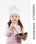 Small photo of A young girl enjoys cooking up something good to eat.