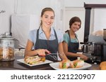 Small photo of Pretty waitresses working with a smile at the coffee shop