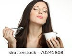 Young female enjoying taste of yogurt isolated on white - stock photo