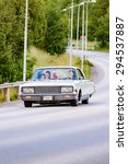 Small photo of RONNEBY, SWEDEN - JUNE 26, 2015: Veteran car street cruise on public roads. Chrysler new yorker 1965 white.